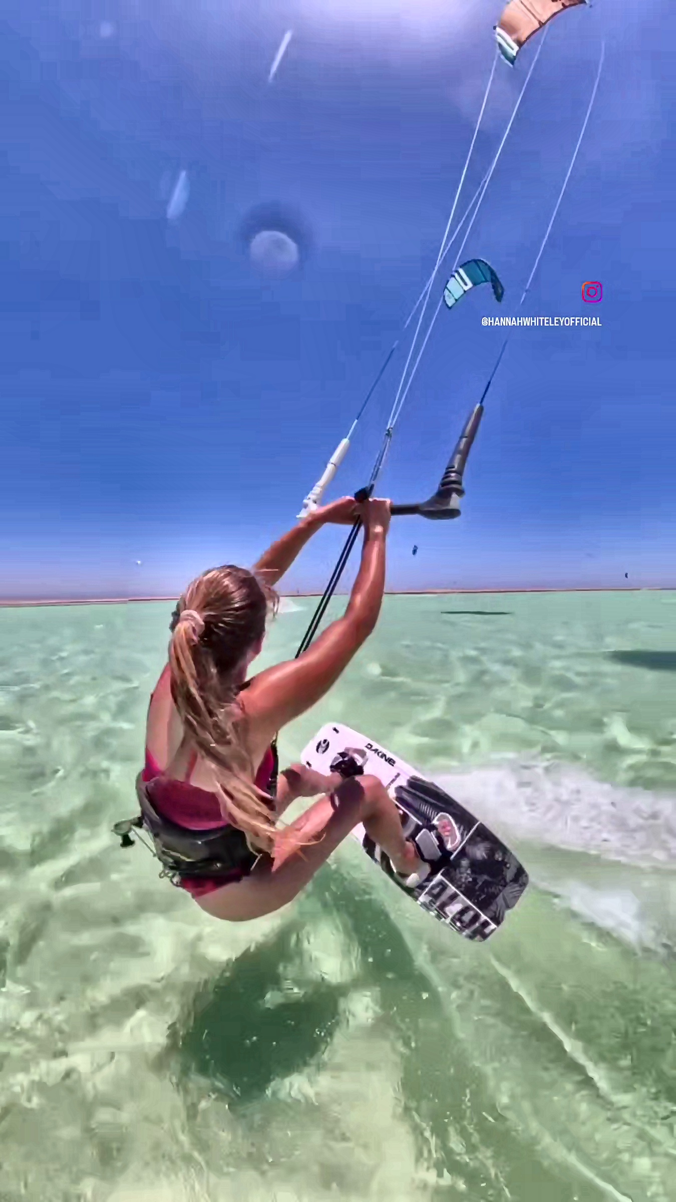 Gliding across clear water with the kite high