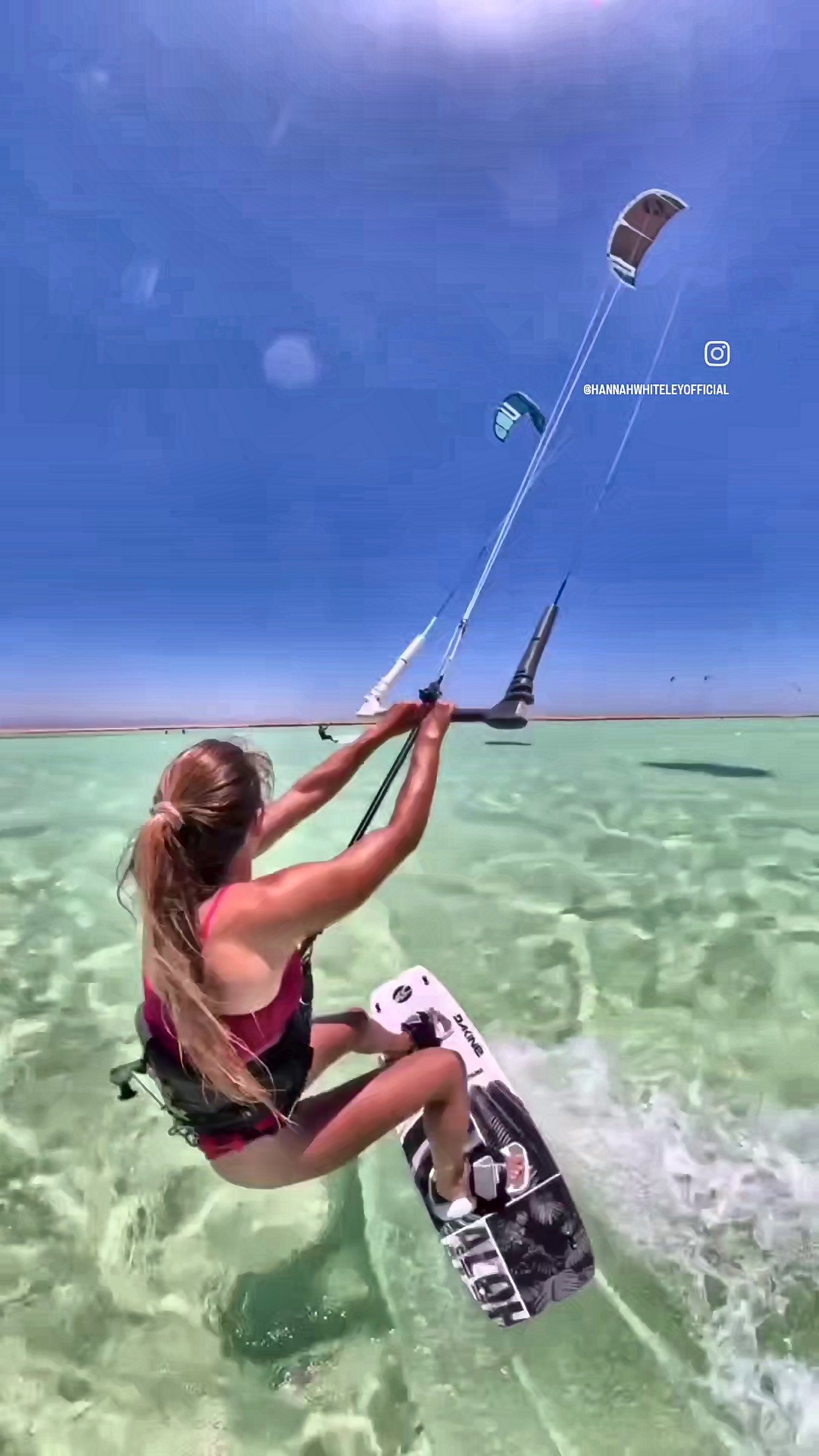 Gliding across clear water with the kite high