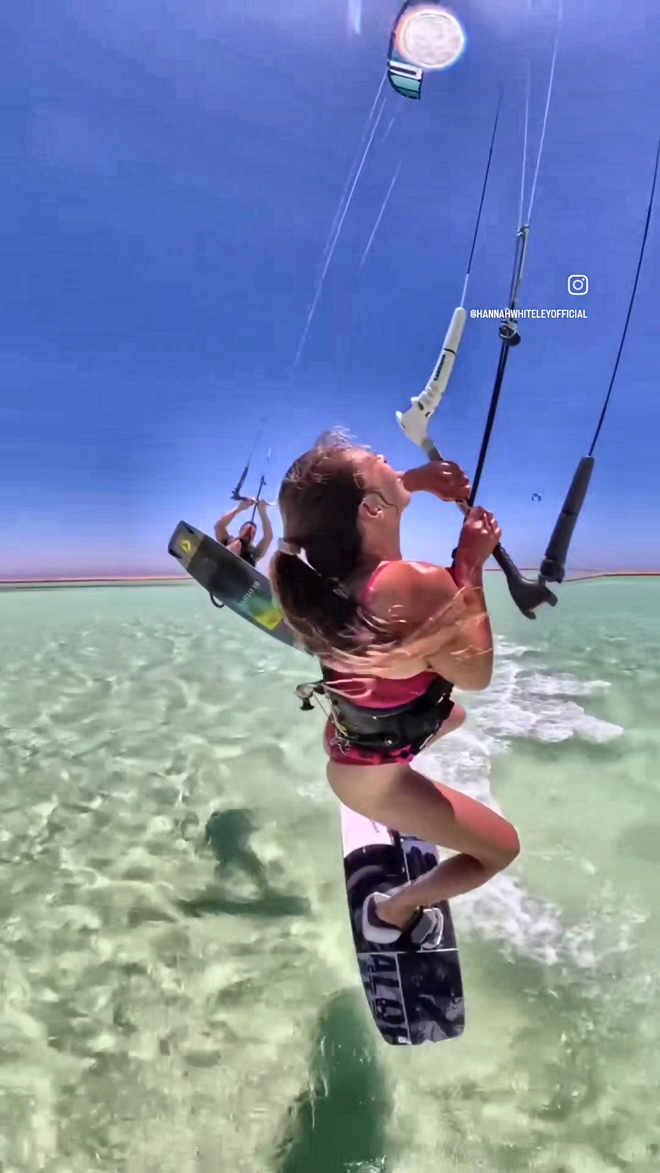 Gliding across clear water with the kite high